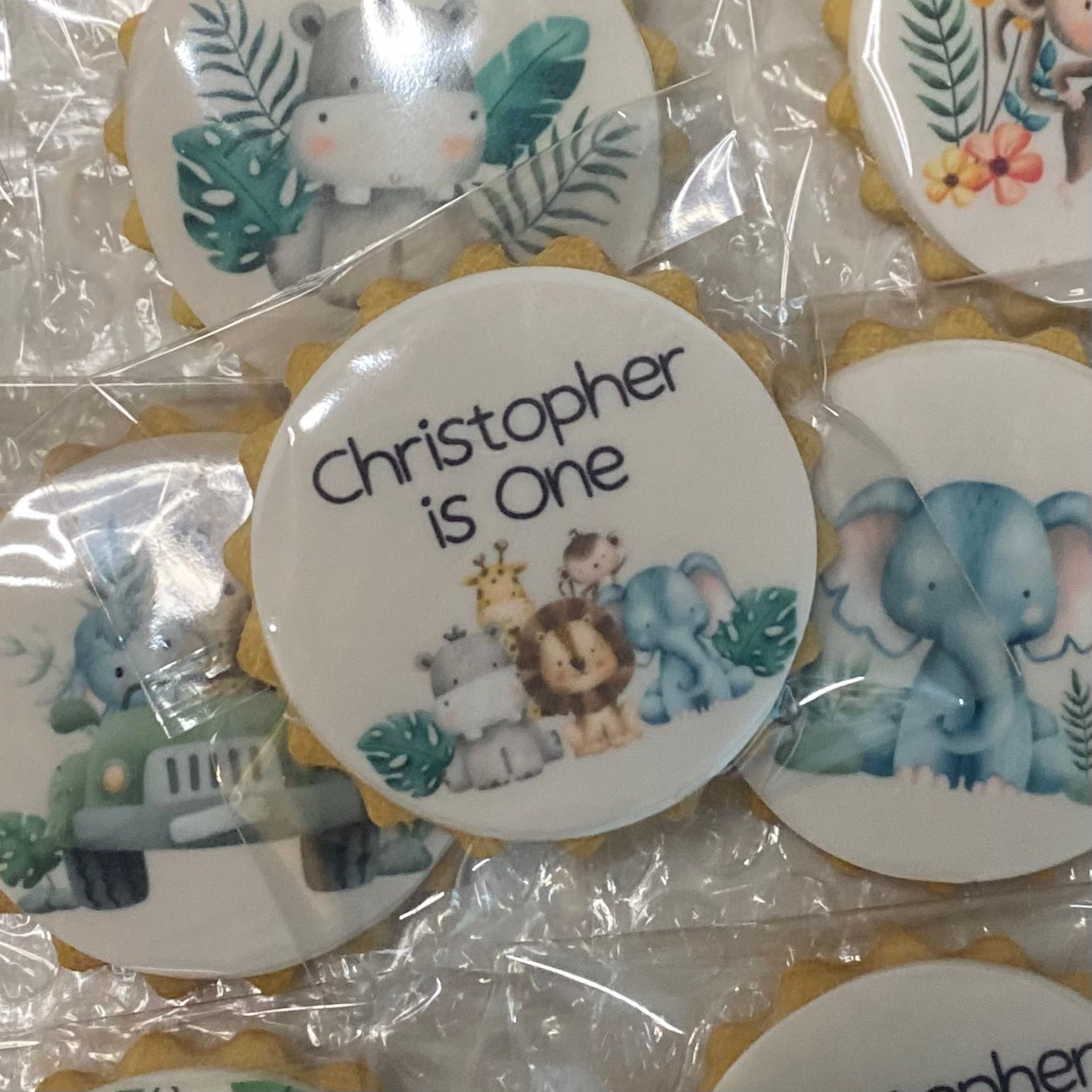 Wild One safari-themed biscuits featuring lion, elephant, and giraffe shapes for a child's birthday party"