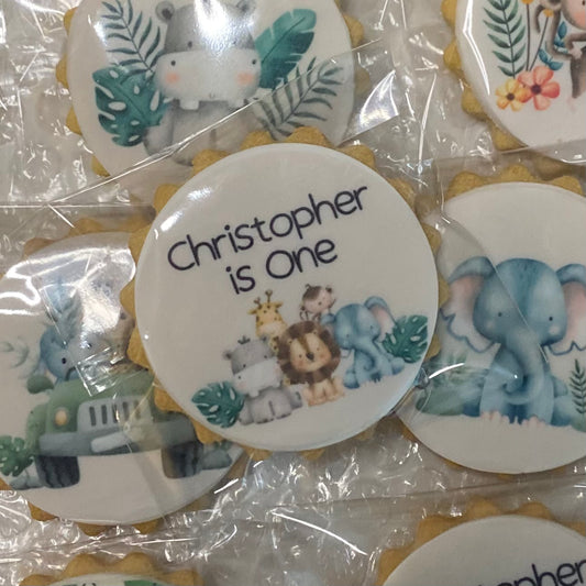 Wild One safari-themed biscuits featuring lion, elephant, and giraffe shapes for a child's birthday party"