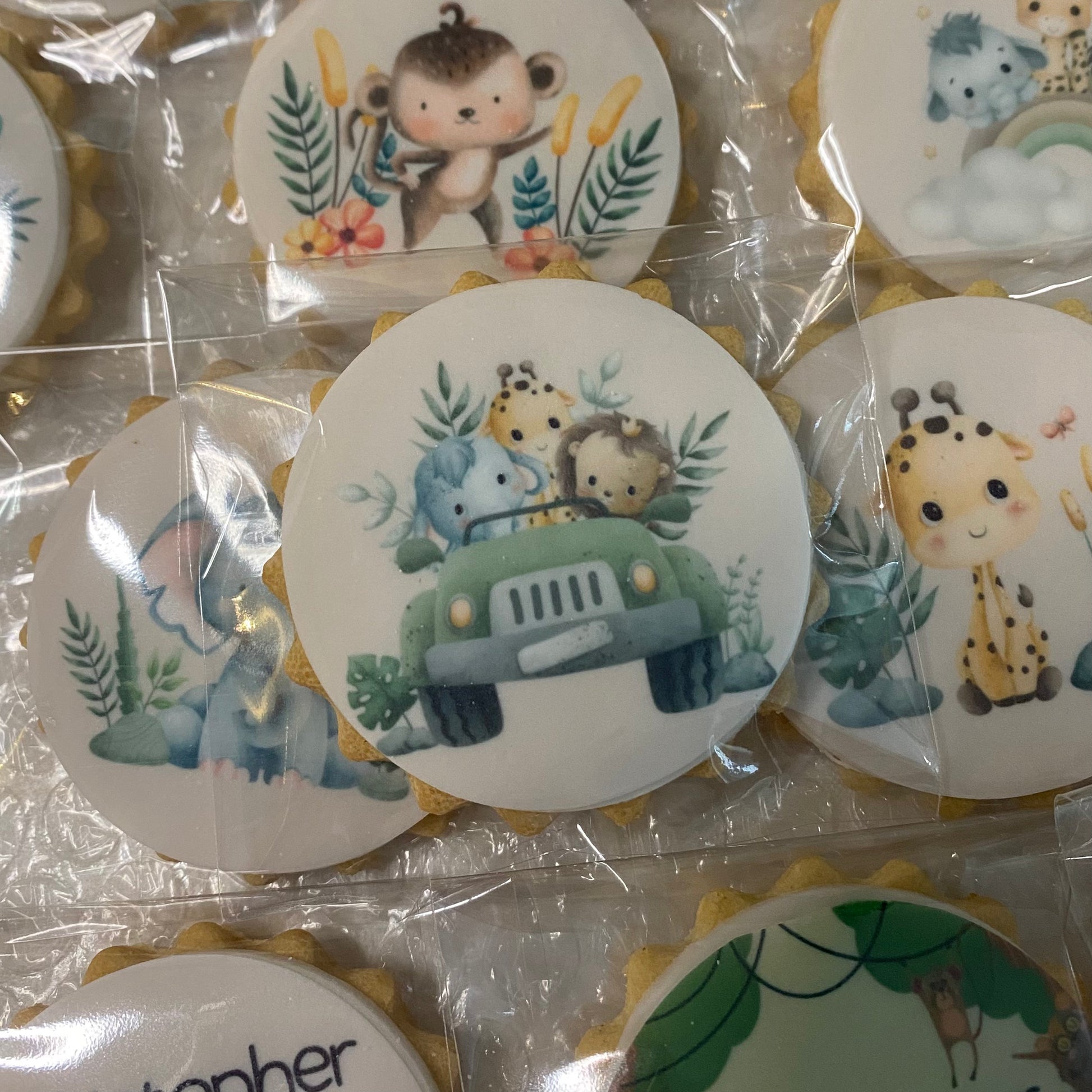 Wild One safari-themed biscuits featuring lion, elephant, and giraffe shapes for a child's birthday party"