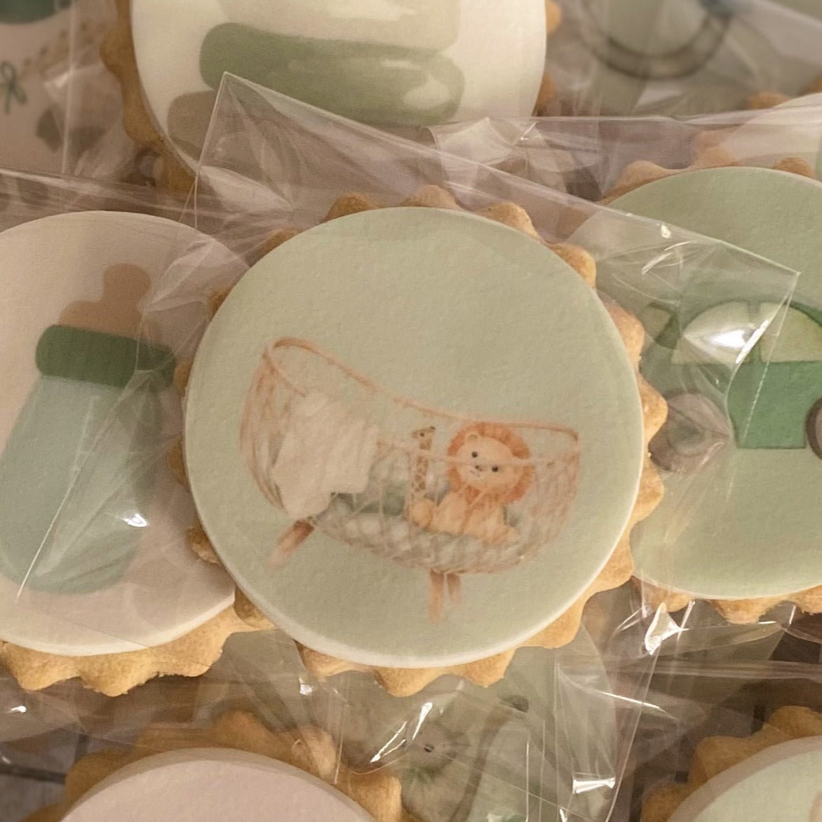 Beautifully decorated baby shower biscuits in pastel and neutral colours