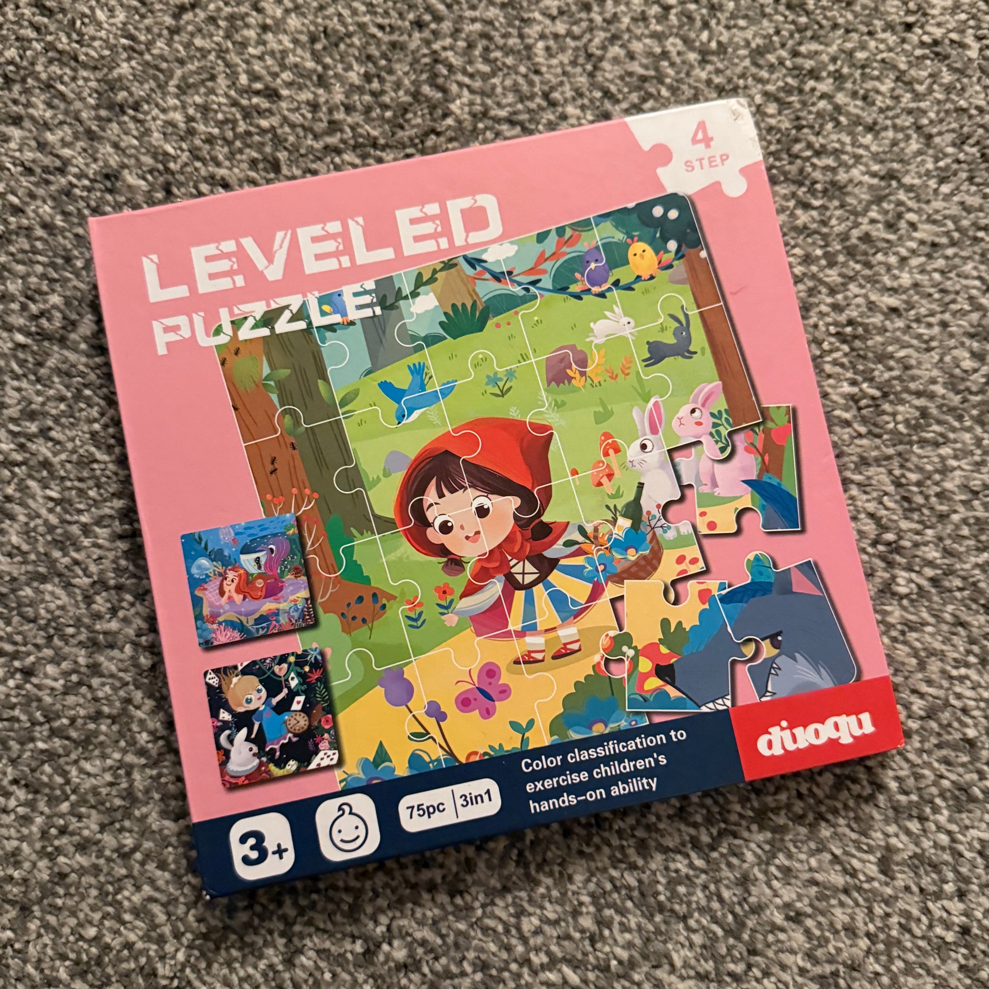 Children's puzzle with cartoon character on a pink box, displayed on a carpeted floor.