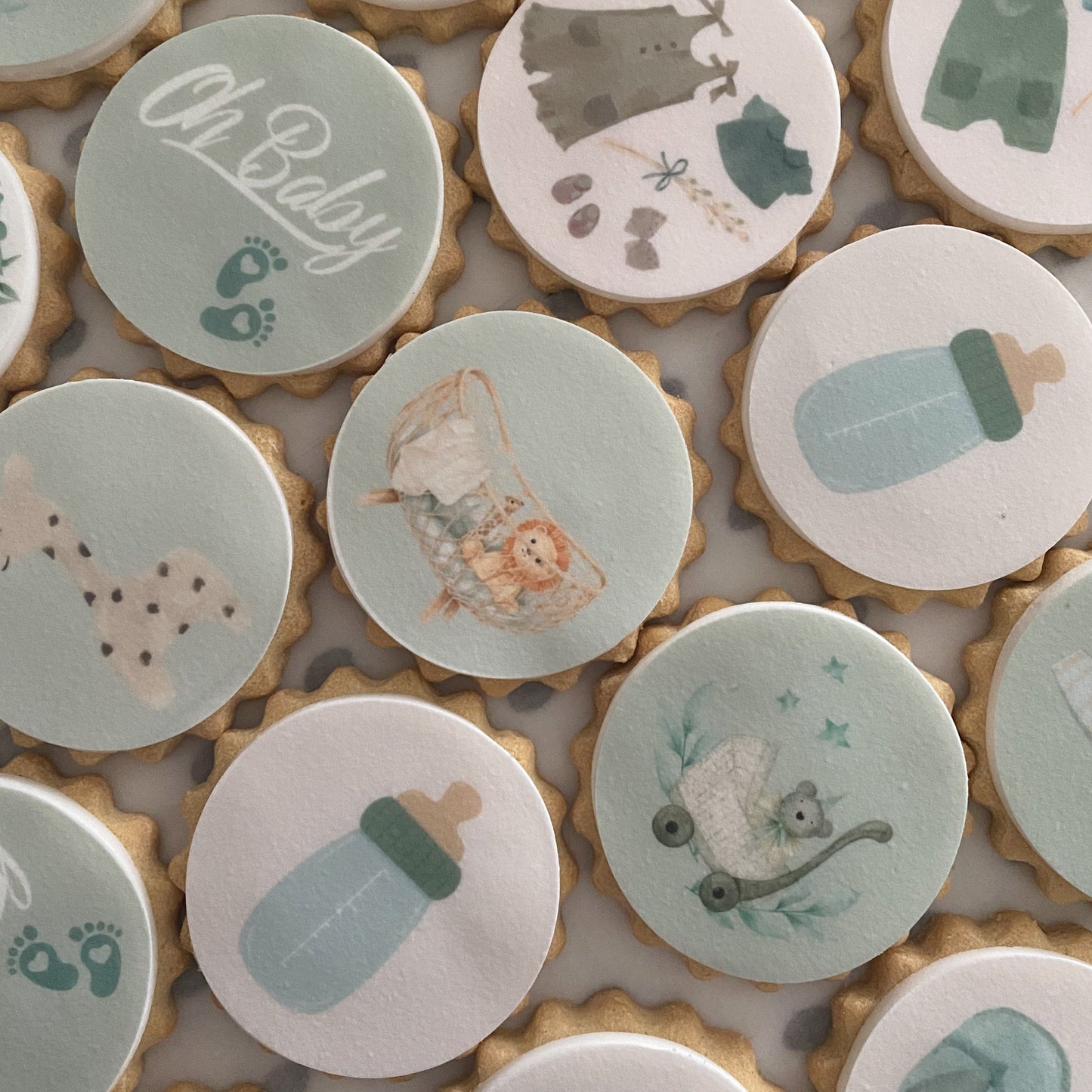 Beautifully decorated baby shower biscuits in pastel and neutral colours