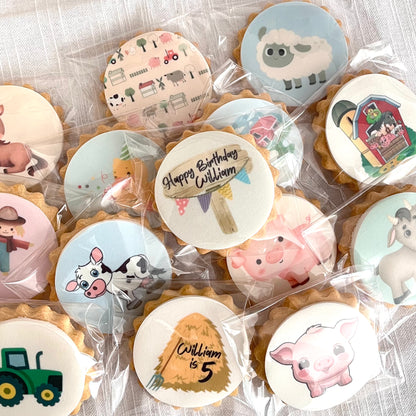A pack of personalized birthday party biscuits for a child, featuring various farm animal designs such as chickens, cows, pigs, and horses, and customized with the child's name and age.