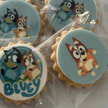 Bluey character biscuits at a fun-filled birthday party - Assorted Bluey and friends character biscuits displayed on a colorful party table