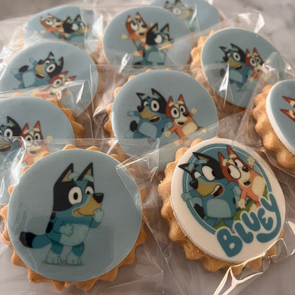 Bluey character biscuits at a fun-filled birthday party - Assorted Bluey and friends character biscuits displayed on a colorful party table